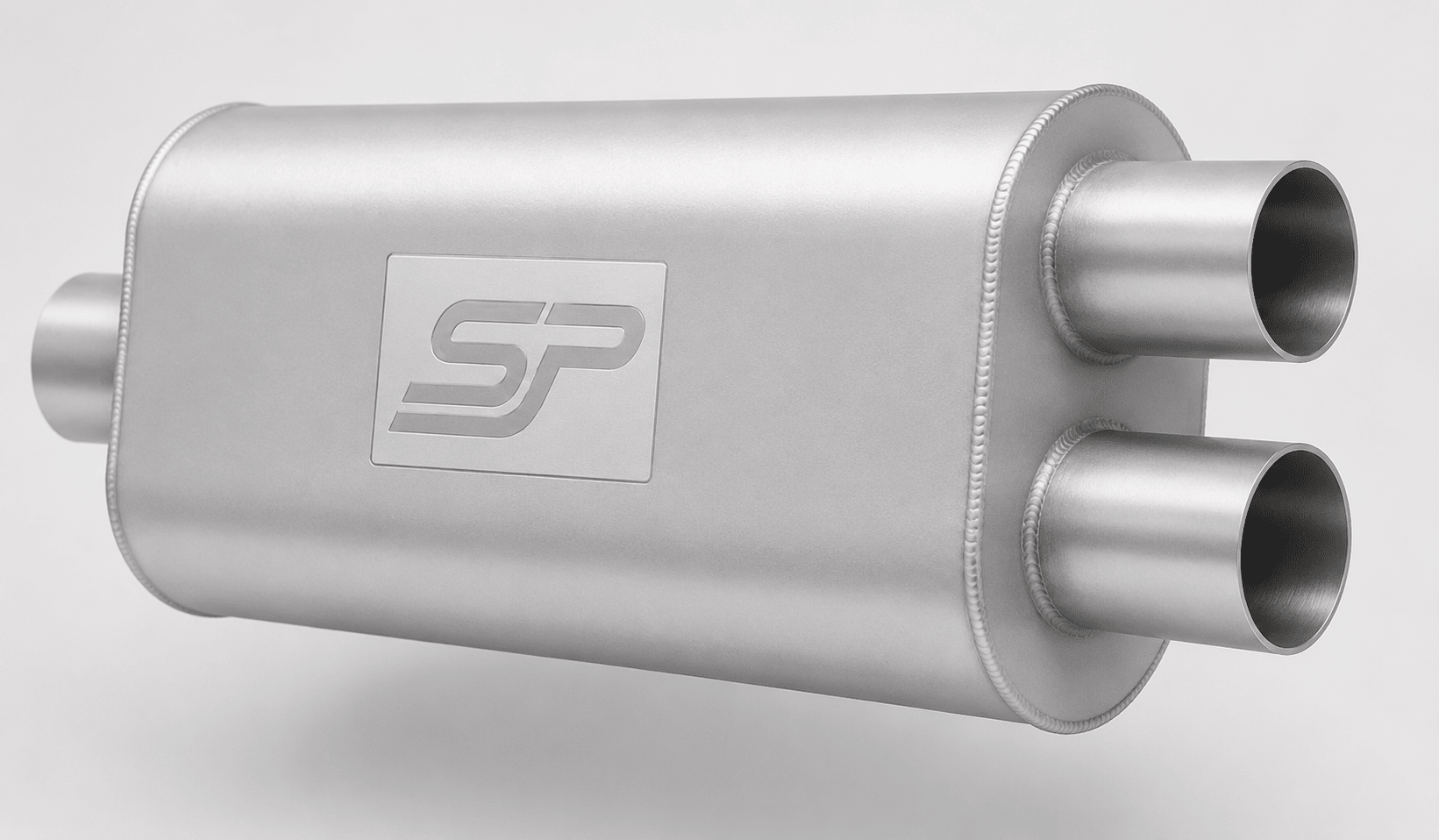 A silver metallic automotive exhaust muffler with dual outlet pipes and a square logo plate on the side, shown on a light gray background.